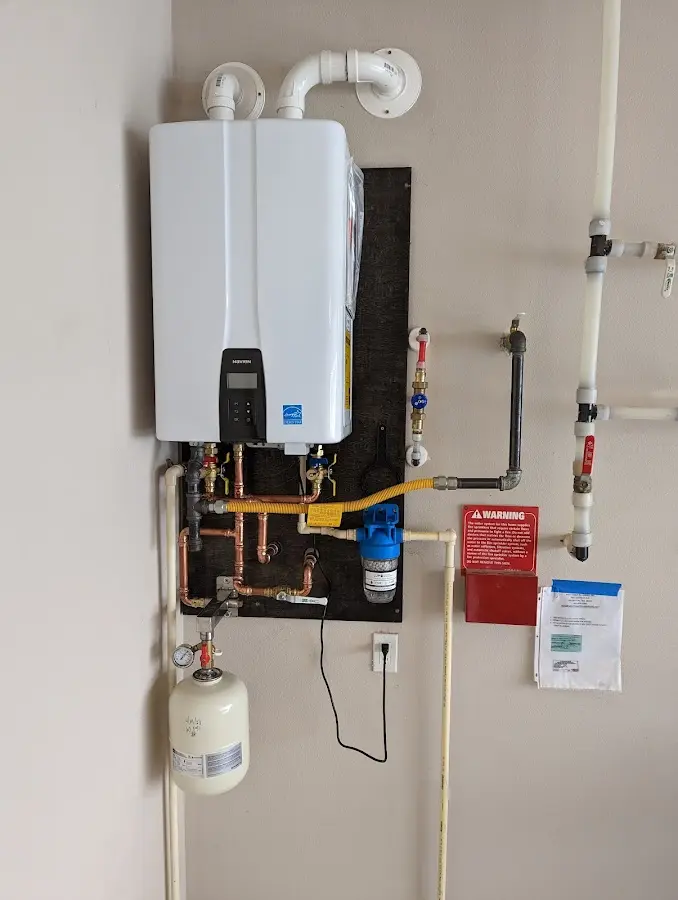 Professional plumber installing copper piping in a Pine City home